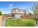 Landscaped backyard with a well-maintained lawn, a wooden fence, and a gardening bed at 3692 Celestial Ave, Castle Rock, CO 80109