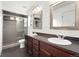 Bathroom with double vanity, modern fixtures, wood-like flooring and glass enclosed shower at 3692 Celestial Ave, Castle Rock, CO 80109