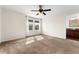 Bright bedroom featuring carpet floors, a ceiling fan, and natural light from the windows at 3692 Celestial Ave, Castle Rock, CO 80109