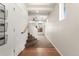 Hallway featuring wood and carpeted floors, white walls, and a stairway at 3692 Celestial Ave, Castle Rock, CO 80109