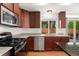 Well-equipped kitchen featuring stainless steel appliances and dark wood cabinets at 3692 Celestial Ave, Castle Rock, CO 80109