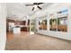 Open-concept living room with kitchen, featuring hardwood floors and large windows for natural light at 3692 Celestial Ave, Castle Rock, CO 80109
