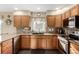 Bright kitchen features stainless steel appliances, tile backsplash, and wood cabinetry at 600 N 15Th Ave, Brighton, CO 80601