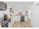 Bright kitchen with butcher block island and white shaker cabinets at 4645 W Princeton Ave, Denver, CO 80236