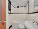 Bathroom featuring updated white tile, classic fixtures, and a vintage medicine cabinet at 1605 Saint Paul St # 6, Denver, CO 80206