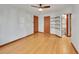 Bright bedroom featuring hardwood floors, ceiling fan, two closets, and convenient bathroom access at 1605 Saint Paul St # 6, Denver, CO 80206