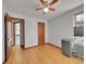 Spacious bedroom featuring a ceiling fan, two doors, hardwood floors and a window at 1605 Saint Paul St # 6, Denver, CO 80206