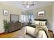Comfortable bedroom featuring a ceiling fan, two windows, hardwood floors and dresser at 1605 Saint Paul St # 6, Denver, CO 80206