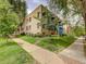 Brick apartment building showcasing mature trees, green lawn and street access at 1605 Saint Paul St # 6, Denver, CO 80206