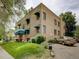 Brick apartment building view showing landscaping, street access, and parking at 1605 Saint Paul St # 6, Denver, CO 80206