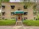 Charming brick building with green awnings, well-maintained landscaping and an inviting entrance at 1605 Saint Paul St # 6, Denver, CO 80206