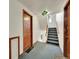 Hallway with door and staircase, carpeted stairs, neutral walls at 1605 Saint Paul St # 6, Denver, CO 80206