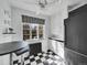 Kitchen with black and white tile flooring, modern appliances, and bright lighting at 1605 Saint Paul St # 6, Denver, CO 80206