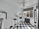 Eat-in kitchen with black and white tile, two stools, and a large window with natural light at 1605 Saint Paul St # 6, Denver, CO 80206