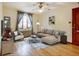 Cozy living room with hardwood floors, large window, stylish furnishings, and contemporary ceiling fan at 1605 Saint Paul St # 6, Denver, CO 80206