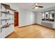 Inviting living room with floating shelves, hardwood floors, large window, and a radiator at 1605 Saint Paul St # 6, Denver, CO 80206