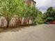 Property view showcasing parking lot with trees and landscaping near building at 1605 Saint Paul St # 6, Denver, CO 80206