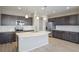 Modern kitchen with a large island, stainless steel appliances, and sleek cabinets at 3342 N Buchanan Way, Aurora, CO 80019