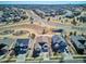 Aerial view of a residential neighborhood featuring well-maintained homes, landscaping, and roadways at 6019 S Little River Way, Aurora, CO 80016