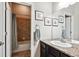 Bathroom with granite countertops, neutral paint color, three matching framed art pieces, and shower-tub combo at 6019 S Little River Way, Aurora, CO 80016