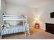 Bright bedroom featuring a bunk bed with colorful bedding, plus a red bedside table and dresser at 6019 S Little River Way, Aurora, CO 80016