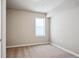 Bright bedroom illuminated by a window with neutral walls and plush carpeting throughout at 6019 S Little River Way, Aurora, CO 80016