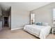 Comfortable bedroom with plush carpeting, a calming color scheme, and natural light from a large window at 6019 S Little River Way, Aurora, CO 80016