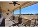 Spacious deck with covered ceiling fans and scenic views of the surrounding neighborhood and landscape at 6019 S Little River Way, Aurora, CO 80016