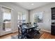 Cozy dining area with a dark wood table, a bench, and a view of the outdoors at 6019 S Little River Way, Aurora, CO 80016