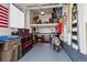 Organized garage with storage solutions, scooter, toolboxes and a clean, epoxy-coated floor at 6019 S Little River Way, Aurora, CO 80016