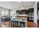 Modern kitchen featuring an island with seating, stainless steel appliances, and sleek dark cabinetry at 6019 S Little River Way, Aurora, CO 80016