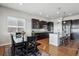 Modern kitchen with an island, seating, stainless steel appliances, and an adjacent dining area at 6019 S Little River Way, Aurora, CO 80016