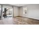 Open living room featuring wood-look tile flooring, sliding glass doors with backyard patio, and recessed lighting at 6019 S Little River Way, Aurora, CO 80016