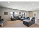 Bright living room featuring a large gray sectional sofa, recessed lights, and large windows with a view at 6019 S Little River Way, Aurora, CO 80016