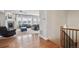 Spacious living room featuring a fireplace, ceiling fan, hardwood floors, and lots of natural light at 6019 S Little River Way, Aurora, CO 80016