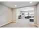 Spacious living room with carpeted floors, recessed lighting, grey sofa, and large windows at 6019 S Little River Way, Aurora, CO 80016