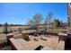 An outdoor patio offers a cozy seating area with a brick fire pit and neighborhood view at 6019 S Little River Way, Aurora, CO 80016