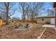 Backyard with fire pit, grill, shed, and covered patio at 2200 Teller St, Lakewood, CO 80214