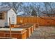 This beautiful backyard features raised garden beds, bee hives, and a convenient shed for gardening enthusiasts at 2200 Teller St, Lakewood, CO 80214