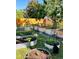 A beautiful backyard features a thriving vegetable garden, enclosed by a charming wooden fence at 2200 Teller St, Lakewood, CO 80214