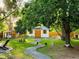 Large backyard with shed, mature trees, and winding path at 2200 Teller St, Lakewood, CO 80214
