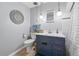 Charming bathroom features a blue vanity, modern fixtures, and stylish decor at 2200 Teller St, Lakewood, CO 80214