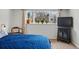 Bedroom with large window, plants, curtains, and entertainment center at 2200 Teller St, Lakewood, CO 80214