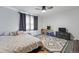 This bedroom is bright and spacious with a patterned rug, play area, and dark curtains at 2200 Teller St, Lakewood, CO 80214