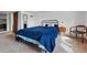 Bedroom with blue comforter, side tables, chair, and closet at 2200 Teller St, Lakewood, CO 80214