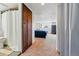 Hallway view of bedroom with large window and TV; bath to left at 2200 Teller St, Lakewood, CO 80214