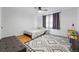 The bedroom includes a ceiling fan, dark curtains, wooden floors, and a patterned rug at 2200 Teller St, Lakewood, CO 80214
