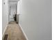 A hallway that leads to another room. The floor is carpeted and there is a vent on the floor at 2200 Teller St, Lakewood, CO 80214