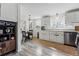 Bright kitchen featuring white cabinets, stainless steel appliances, and an eat in dining space at 2200 Teller St, Lakewood, CO 80214
