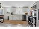 Bright kitchen featuring white cabinets, stainless steel appliances, and a window over the sink at 2200 Teller St, Lakewood, CO 80214